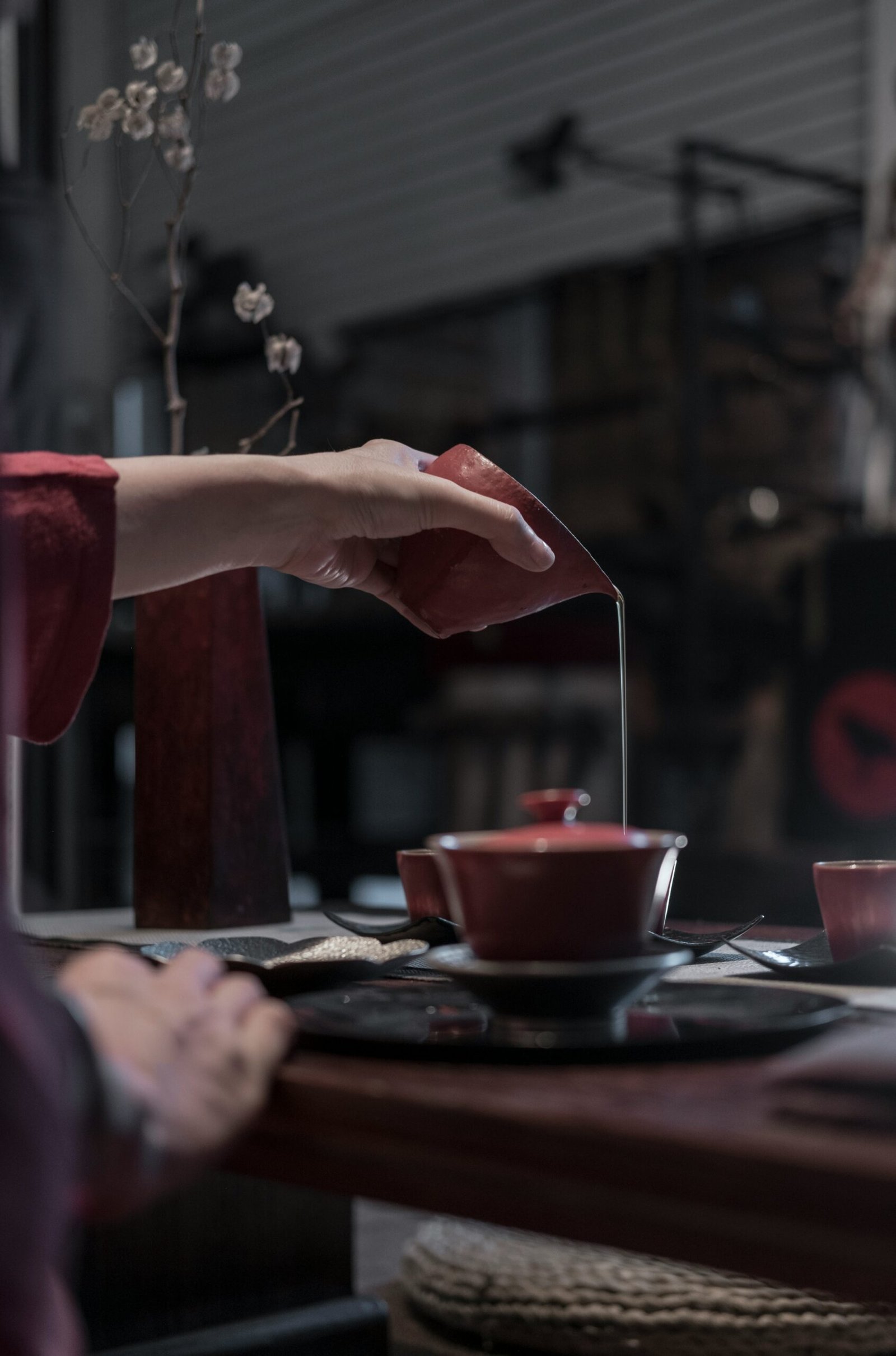 person pouring liquid on cup